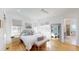 Bright bedroom featuring light wood floors, ceiling fan, and ensuite bathroom view at 2312 Rushland Landing Rd, Johns Island, SC 29455