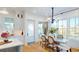 Bright dining area with hardwood floors, a stylish chandelier, and a grandfather clock at 2312 Rushland Landing Rd, Johns Island, SC 29455