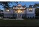 Inviting two-story house with a well-lit entrance, charming shutters, and manicured landscaping at 2312 Rushland Landing Rd, Johns Island, SC 29455