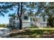Charming home with a raised foundation, elevated screened porch, and a staircase leading to the front door at 2312 Rushland Landing Rd, Johns Island, SC 29455