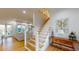 Bright foyer showcasing an open staircase, wood floors, and stylish decor; with views to living area at 2312 Rushland Landing Rd, Johns Island, SC 29455