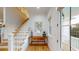 Bright foyer showcasing an open staircase, wood floors, and stylish decor; with views to exterior at 2312 Rushland Landing Rd, Johns Island, SC 29455