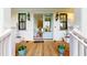 Charming front porch with a light blue double front door, wooden flooring, and black window frames with lantern sconces at 2312 Rushland Landing Rd, Johns Island, SC 29455