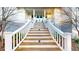 Welcoming front entrance featuring a detailed staircase, a classic white railing, and a blue-painted porch ceiling at 2312 Rushland Landing Rd, Johns Island, SC 29455