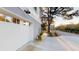 Attached two car garage with carriage doors, exterior lighting, and a concrete driveway at 2312 Rushland Landing Rd, Johns Island, SC 29455