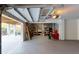 Spacious garage featuring gray floors, concrete block walls, storage shelving, and a screened patio with outdoor furniture at 2312 Rushland Landing Rd, Johns Island, SC 29455