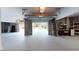Spacious two-car garage with concrete block walls, epoxy floors, and an open garage door with view of the property at 2312 Rushland Landing Rd, Johns Island, SC 29455