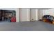 A spacious garage with gray epoxy floors, white walls, and a large storage area for household items and tools at 2312 Rushland Landing Rd, Johns Island, SC 29455