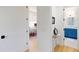 Hallway view into an office and bathroom with white walls and wooden floors, and a bright aesthetic at 2312 Rushland Landing Rd, Johns Island, SC 29455