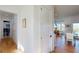 Bright hallway with hardwood floors leading to the dining area and featuring elegant white trim at 2312 Rushland Landing Rd, Johns Island, SC 29455