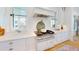 Bright kitchen showcasing a stainless steel range with modern vent hood, and white cabinets and countertops at 2312 Rushland Landing Rd, Johns Island, SC 29455