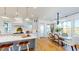 Open-concept kitchen and dining area filled with natural light, features hardwood floors and modern lighting at 2312 Rushland Landing Rd, Johns Island, SC 29455
