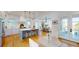 Modern kitchen with stainless steel appliances, island with seating, and adjacent dining area with outdoor views at 2312 Rushland Landing Rd, Johns Island, SC 29455