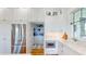 A bright kitchen with stainless steel appliances, custom cabinets, a pantry, and marble countertops at 2312 Rushland Landing Rd, Johns Island, SC 29455
