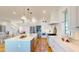 Bright kitchen with white cabinets, stainless steel appliances, and a large island, open to the living area at 2312 Rushland Landing Rd, Johns Island, SC 29455