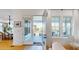 Bright living room with wood floors, multiple windows, and french doors leading to a patio overlooking the water at 2312 Rushland Landing Rd, Johns Island, SC 29455