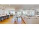 Open floor plan connecting kitchen, dining area, and living room with hardwood floors and bright, natural light at 2312 Rushland Landing Rd, Johns Island, SC 29455