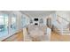 Bright living room featuring a fireplace, built-in shelving, hardwood floors and access to an outdoor patio at 2312 Rushland Landing Rd, Johns Island, SC 29455