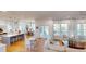 Open-concept living space with a modern kitchen, cozy seating area, dining area, and large windows overlooking water views at 2312 Rushland Landing Rd, Johns Island, SC 29455