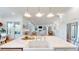 Open-concept living space featuring a bright kitchen with stainless appliances flowing into the living room with fireplace at 2312 Rushland Landing Rd, Johns Island, SC 29455