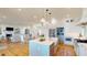 Open-concept kitchen and living space featuring white cabinets, a large island, and a cozy fireplace at 2312 Rushland Landing Rd, Johns Island, SC 29455
