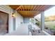 Covered back patio featuring concrete flooring, an outdoor dining set, and an adjacent stairwell to the backyard at 2312 Rushland Landing Rd, Johns Island, SC 29455