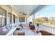 Spacious porch with comfortable seating that overlooks the lake and trees at 2312 Rushland Landing Rd, Johns Island, SC 29455