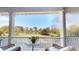 Scenic porch view of lake with lush trees, lawn, and a neighboring home visible in the distance at 2312 Rushland Landing Rd, Johns Island, SC 29455