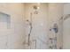 Close-up of a shower featuring white marble tile and modern fixtures at 2312 Rushland Landing Rd, Johns Island, SC 29455