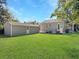 Spacious backyard with a green lawn, a shed, and a view of the rear of the house at 2313 Kent Ave, North Charleston, SC 29405