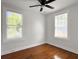 Bright bedroom features two windows, a ceiling fan, and beautiful hardwood floors at 2313 Kent Ave, North Charleston, SC 29405