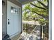 Inviting front porch with a light blue door, offering a view of a meticulously landscaped yard and neighborhood at 2313 Kent Ave, North Charleston, SC 29405