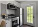 Galley kitchen features stainless appliances, granite countertops, and a door to the backyard at 2313 Kent Ave, North Charleston, SC 29405