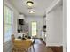 Bright kitchen featuring white cabinets, stainless steel appliances, and a cozy dining area with wood floors at 2313 Kent Ave, North Charleston, SC 29405