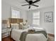 Light-filled main bedroom offers a ceiling fan, two windows, and wood flooring at 2313 Kent Ave, North Charleston, SC 29405