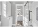Bathroom boasts stylish shower with glass door, wood-look floor, and vanity at 2340 Salt Wind Way, Mount Pleasant, SC 29466