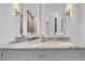 Elegant bathroom with double vanity, marble countertop, and framed mirrors with designer sconces above each sink at 2340 Salt Wind Way, Mount Pleasant, SC 29466