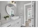 Bathroom featuring a modern sink, round mirror, and elegant finishes at 2340 Salt Wind Way, Mount Pleasant, SC 29466
