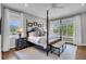 Serene main bedroom with a four-poster bed, ample natural light, and neutral color scheme at 2340 Salt Wind Way, Mount Pleasant, SC 29466