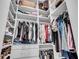 Organized walk-in closet with custom shelving, hanging rods, drawers, and dedicated space for shoes and accessories at 2340 Salt Wind Way, Mount Pleasant, SC 29466