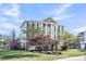 Charming three-story home with classic design, beautiful landscaping, and inviting curb appeal at 2340 Salt Wind Way, Mount Pleasant, SC 29466