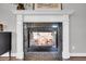 Close-up of a marble fireplace with a stylish mantel, and cozy living room reflected in glass at 2340 Salt Wind Way, Mount Pleasant, SC 29466