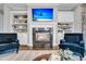 Cozy fireplace flanked by built-in shelving, creating a warm and inviting focal point in the living room at 2340 Salt Wind Way, Mount Pleasant, SC 29466