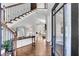 Grand foyer showcasing a staircase with dark iron railings, wood floors, and elegant décor, leading into the living spaces at 2340 Salt Wind Way, Mount Pleasant, SC 29466