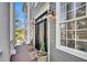 Charming front entrance showcasing a decorative door, sidelights, and manicured potted plants at 2340 Salt Wind Way, Mount Pleasant, SC 29466