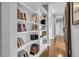 Hallway featuring hardwood floors, built-in bookshelves, and a cozy ambiance at 2340 Salt Wind Way, Mount Pleasant, SC 29466