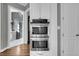 A modern kitchen featuring stainless steel double ovens and white cabinets, seamlessly connected to the home's other spaces at 2340 Salt Wind Way, Mount Pleasant, SC 29466