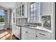 Kitchen sink boasts windows, mosaic backsplash, and stainless steel appliances at 2340 Salt Wind Way, Mount Pleasant, SC 29466