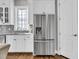 Modern kitchen design with sleek stainless steel refrigerator and white cabinetry at 2340 Salt Wind Way, Mount Pleasant, SC 29466