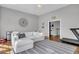 Casual living room with a cozy white sofa, accent decor, and a view into a separate room with home fitness equipment at 2340 Salt Wind Way, Mount Pleasant, SC 29466